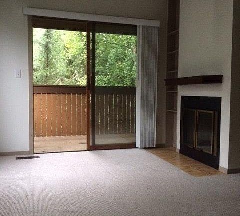 living room w/ vaulted ceilings & fire place