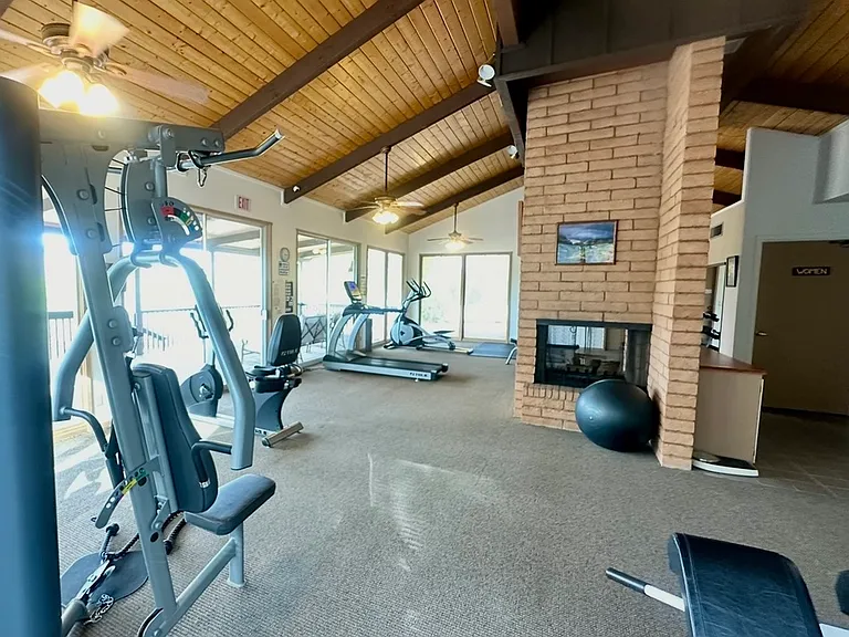 Gym with cardio, weight machines, benches and free weights.