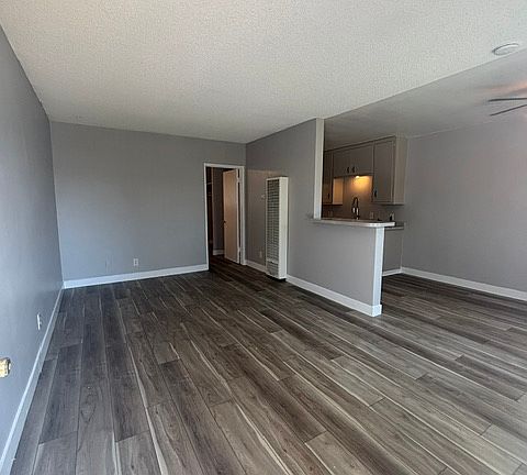 Large living room with new vinyl plank flooring and fresh paint