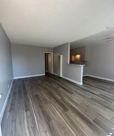 Large living room with new vinyl plank flooring and fresh paint