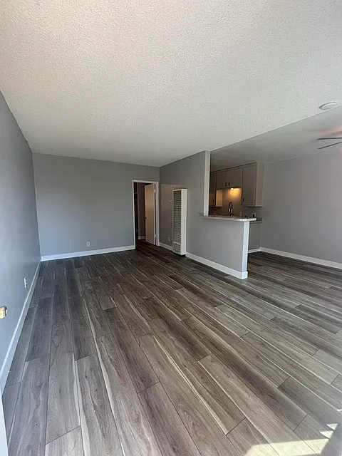 Large living room with new vinyl plank flooring and fresh paint