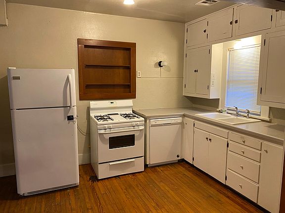 Kitchen with stove top, dishwasher, refrigerator and garbage disposal in sink. Plenty of storage.
