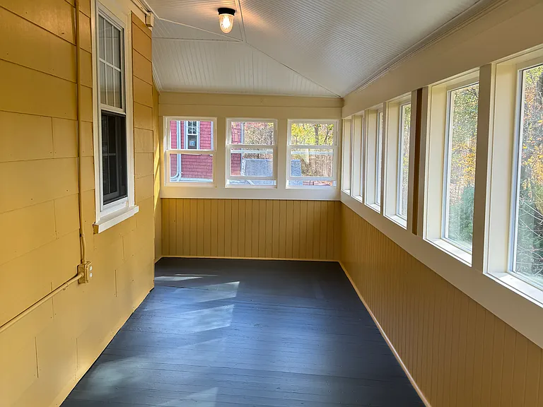 This is a photo taken from another direction. It's a great area to bird watch. With both an electrical outlet and a light on the porch ceiling. When open the window screens enable airflow during the summer months. When they're closed it's toastier.