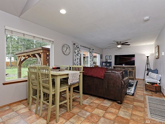 This is the dining/family room, with slider leading to the back yard. There's a door to the right that leads to the utility room and then to the garage.