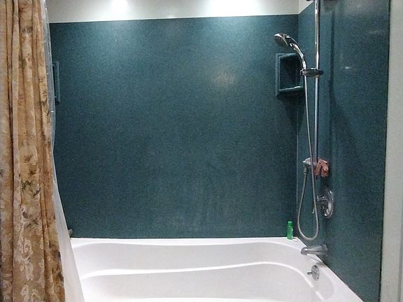 2nd fl. Oversized tub with shower Silestone enclosure and recessed lighting.