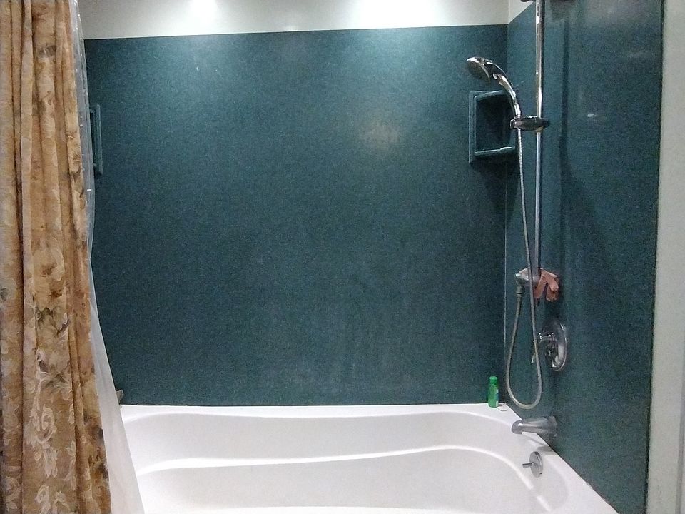 2nd fl. Oversized tub with shower Silestone enclosure and recessed lighting.