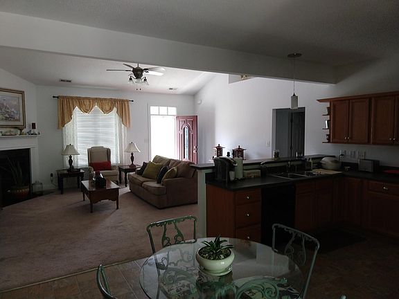 The view from the back door. Gas fireplace on the left. The hallway on the right leads to two bedrooms and a bathroom.