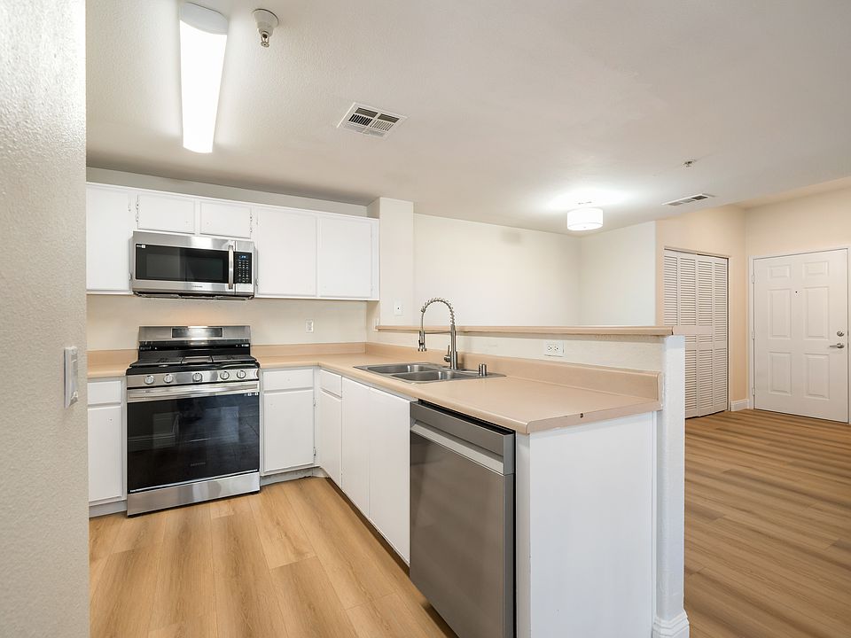 Kitchen opens to dining area and bar top seating area