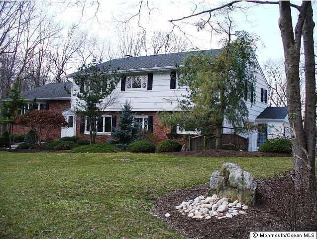 High on a knoll this special home graces two gorgeous acres of rolling woodlan