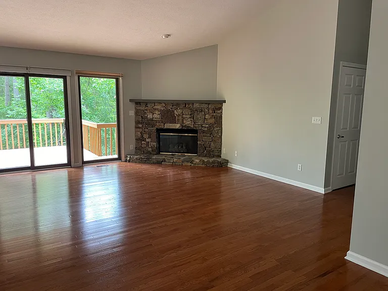 Living room with gas fireplace and full wall of doors to the elevated deck.