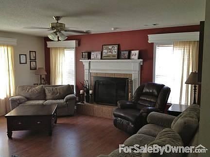 Large living room : wood burning fireplace with custom mantel, wood blinds and cornice boards.