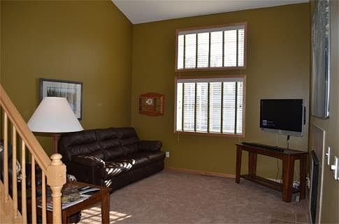 Nearly 2-story living room with beautiful double windows allowing tons of natural light into the home.