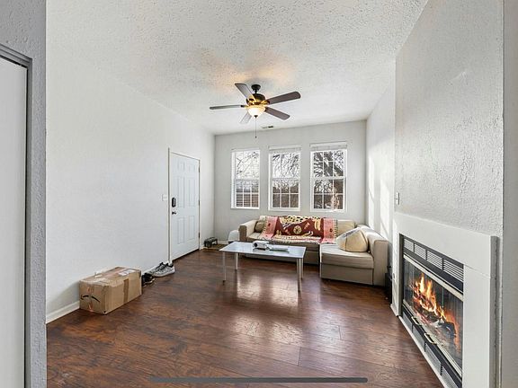 Standing in the dining area, facing the living room you can see plenty of space with west-facing windows bathing the room in natural light.