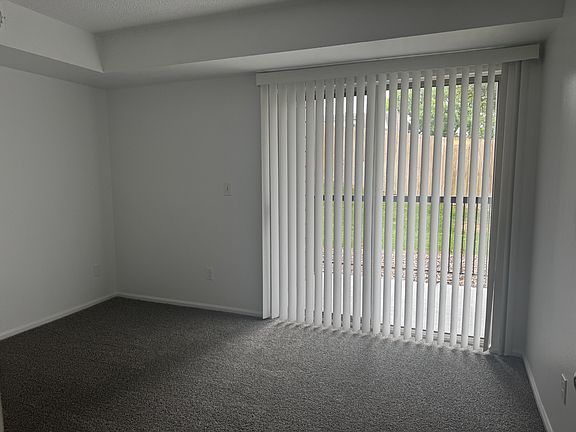 Primary bedroom with walkout to patio area with privacy area--large closet