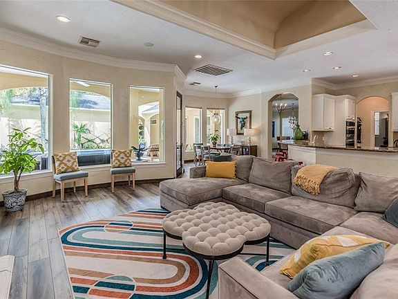 Natural light pours into all rooms of the home! Open Living, Kitchen, and Breakfast Room seen overlook the covered Veranda and pool area. Foundation was repaired in last year with transferable warranty to new Buyer. All Downstairs floors were replace