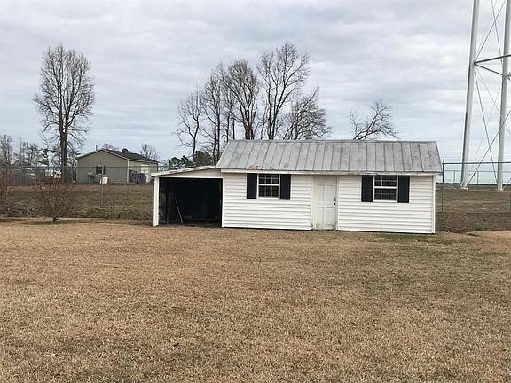 Wired Outbuilding with Vinylsiding and Attached Covered Shelter