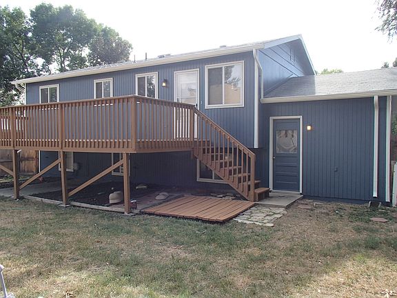 Back of house with large fenced yard and huge deck