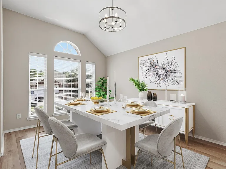 Vaulted ceiling dining area featuring wood-finish flooring, a contemporary chandelier, multiple windows with blinds, and a built-in buffet cabinet