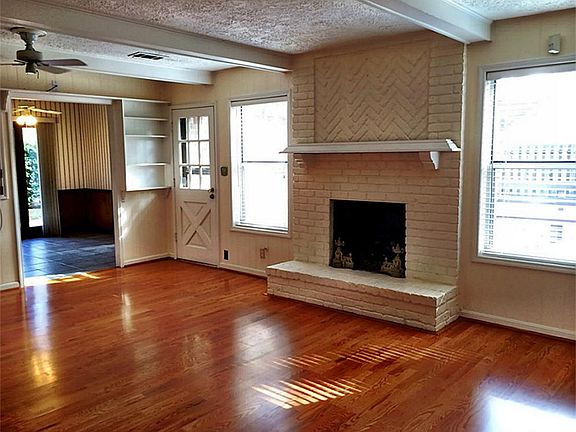 LIVING ROOM FEATURES NATURAL LIGHT AND EXPOSED BRICK