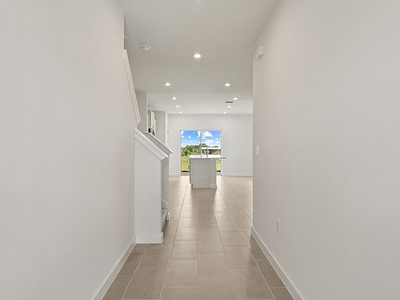 Welcoming entryway in the Ponte Vedra home with sleek flooring, recessed lighting, and a clean and m