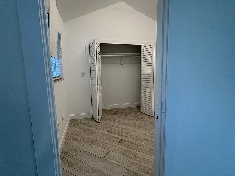 Entrance to bedroom. Please note all walls are white, lighting made it blue