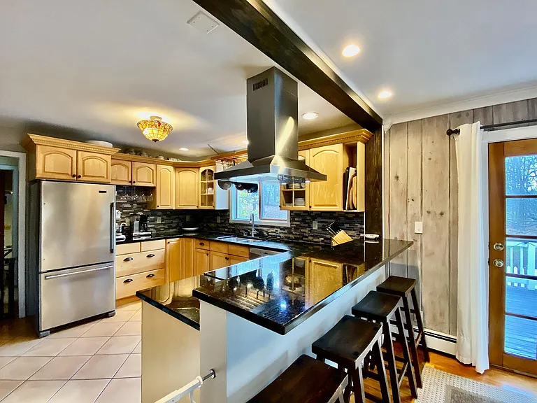 Granite counter tops, stainless steel appliances, and double sink.