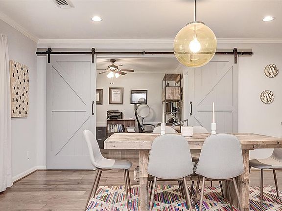 Dining room off of entrance with lots of natural light and beautiful engineered wood floors. A great bar with bamboo counter tops and a beverage fridge.