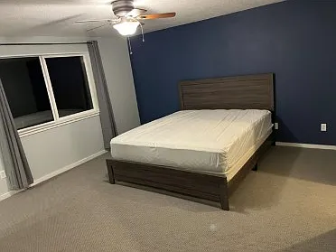 Large master bedroom with king size bed and walk-in closet