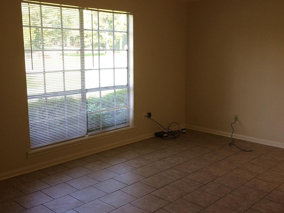 Large living room with tall double windows. Windows are new, double-pane energy efficient windows.