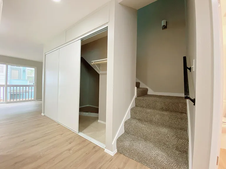 Entry with spacious storage closet under the stairs to bedroom and full bath upstairs