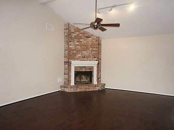 Family room features a corner fireplace