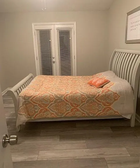 Second bedroom with plank floors.
