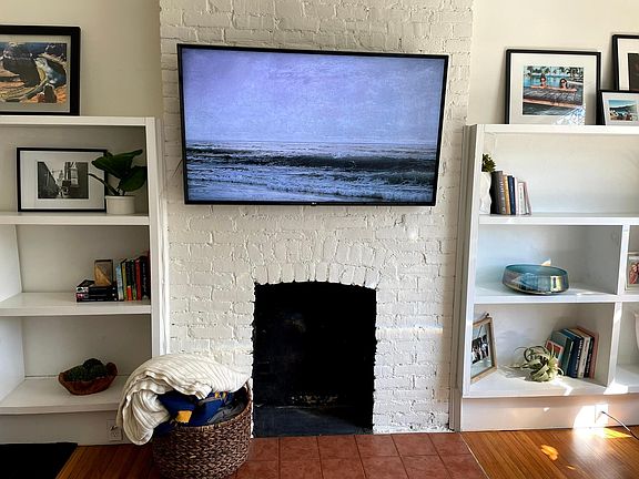 Decorative fireplace with TV mount above (TV not included - fireplace inoperable)