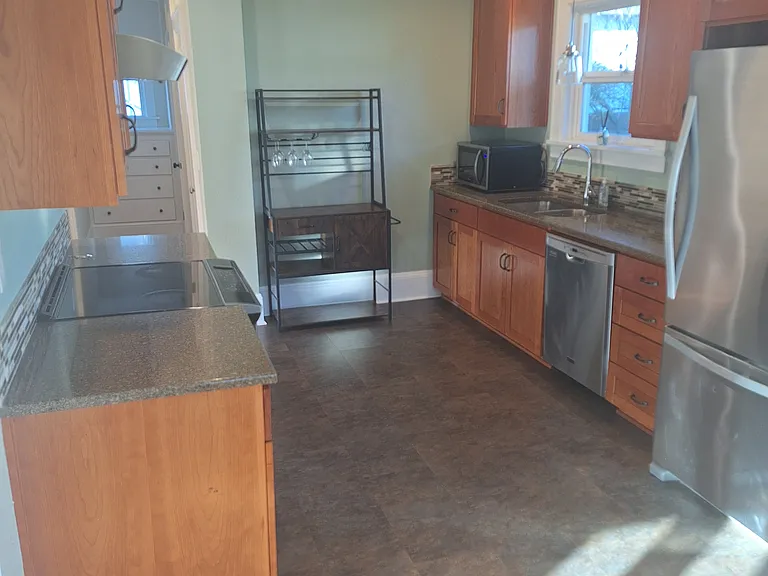 Kitchen bar, wine rack stays with rental
