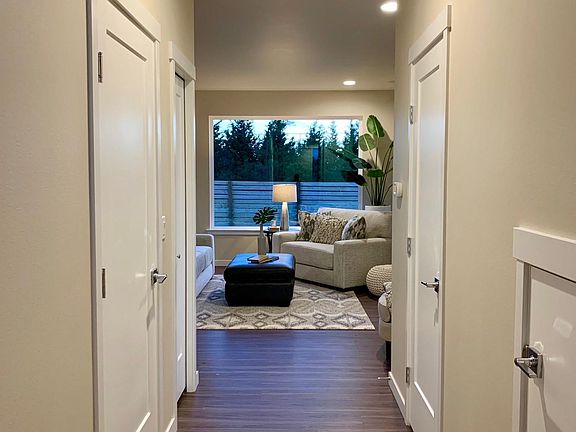 Entry hall with door to the garage on the left and a half bath on the right. The great room is at the back of the house.