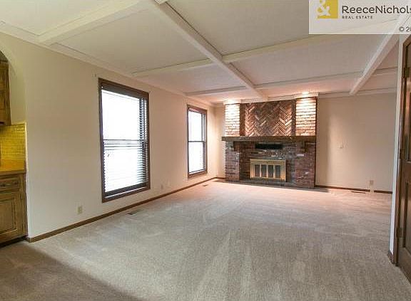 Spacious area with new carpet, wood burning fireplace and wet ba