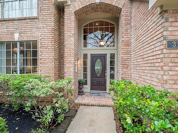 ALL BRICK ENTRY COVERED PORCH WITH STACKED WINDOWS