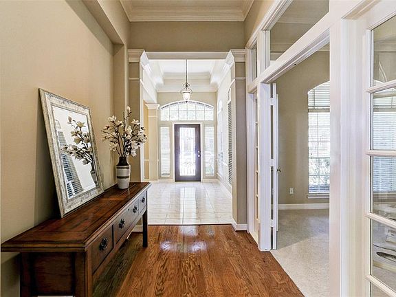As you enter the glass leaded front door, an exclusive formal dining room is on your right. The wood floor leads you to a private, airy study on your left and straight ahead to the Great room and kitchen!