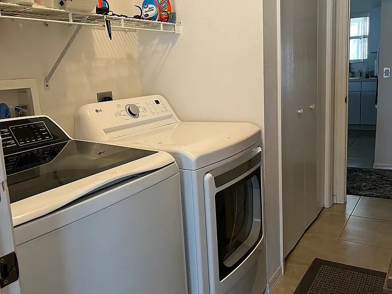 Laundry room with new washer and dryer and large closet for food and shoe storage
