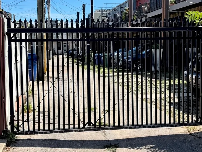 Automatic alley gate to parking pad