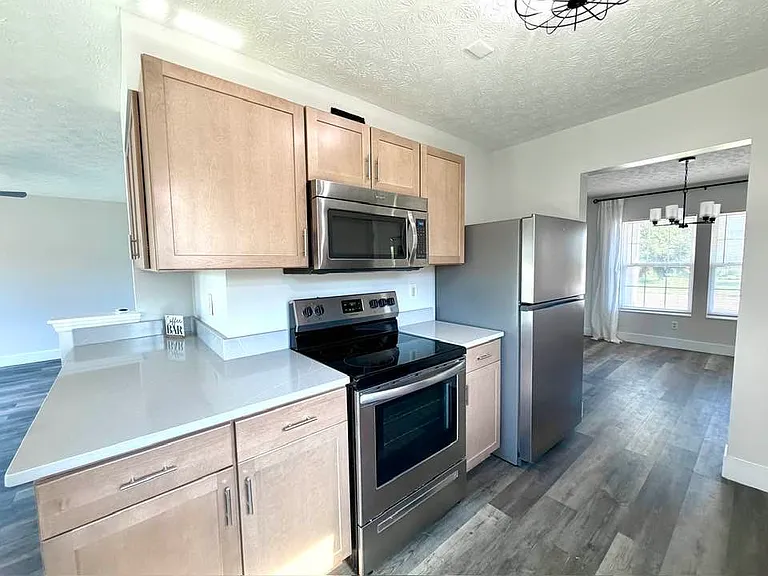 All new kitchen with quartz countertops and stainless appliances