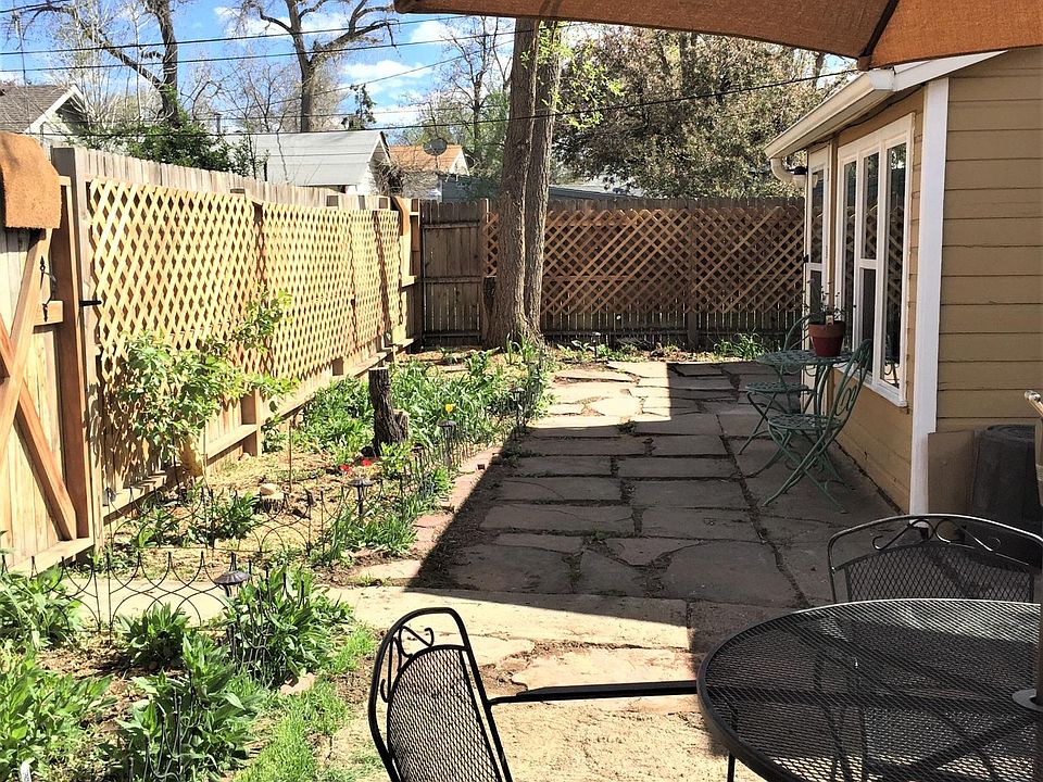 Private yard with flagstone, granite and perennial foliage