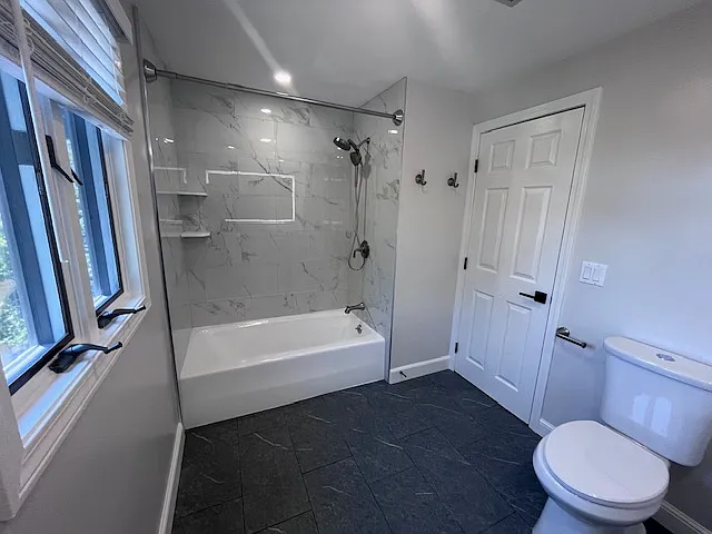 Spacious bathroom with new tile and quartz countertops