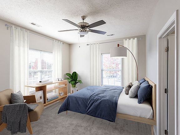 Experience tranquility in this elegantly designed bedroom, featuring abundant natural light and chic furnishings.