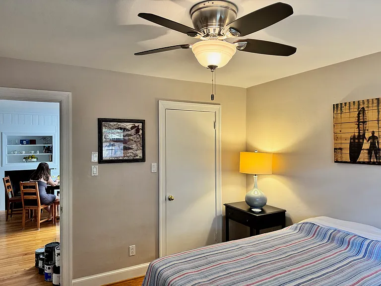 Bedroom 1 of 2 with spacious closet and view into dining area. Hardwood floors and fully furnished!