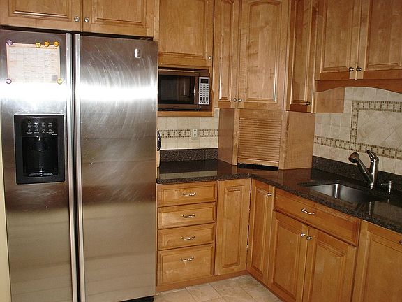 New gourmet kitchen with silestone counters, Viking range and marble floors