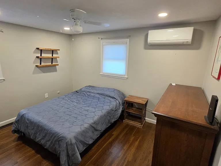 2nd bedroom with queen adjustable bed, mini split and dresser.