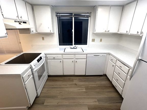 The kitchen has a new countertops, a new stove/oven and new flooring.