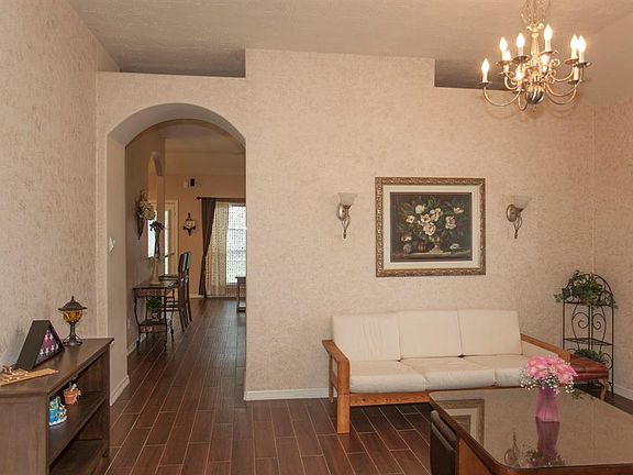 Another hallway off the formal dining/living room connects to the kitchen and to the main living area...