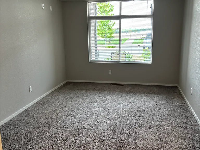 Large bedroom window with views of the mountains.